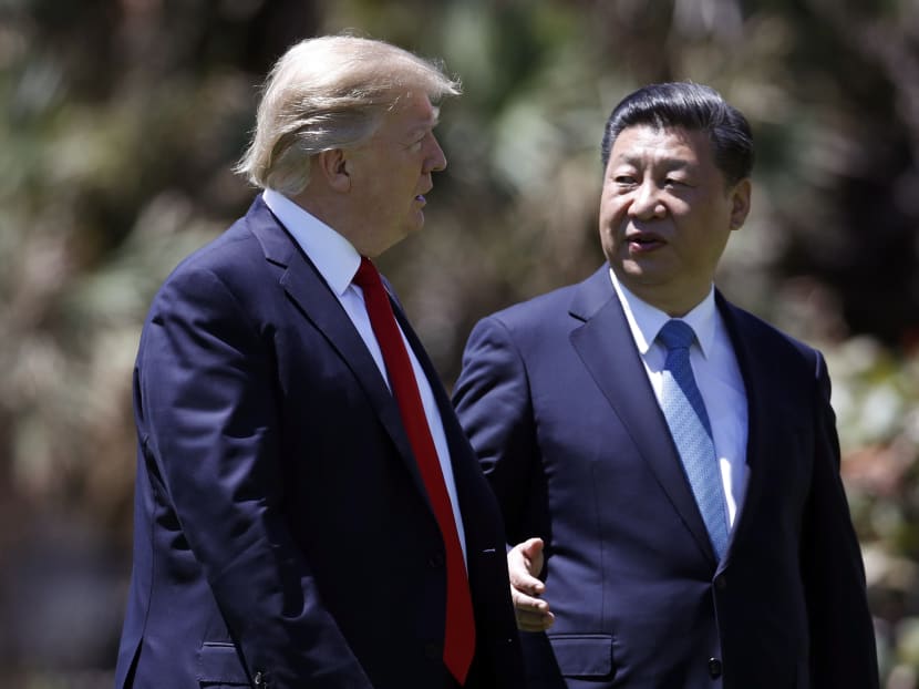 President Donald Trump and Chinese President Xi Jinping walking together after their meetings at Mar-a-Lago on April 7, 2017, in Palm Beach, Florida. Photo: AP
