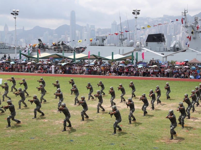 The People’s Liberation Army (PLA) soldiers show their skills during a naval base open day in Hong Kong. The PLA has had a presence in Hong Kong since the city’s return to Chinese sovereignty.