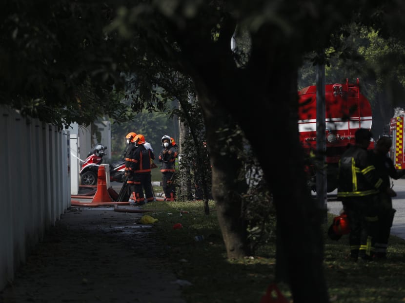 Firefighters are seen at the site of an early morning fire located 11 Kranji Crescent at around 9.30am. Photos: Najeer Yusof/TODAY
