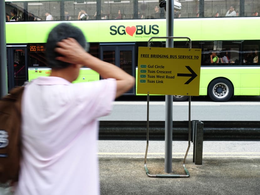 A man looks at a sign directing him to free bus bridging services near Joo Koon MRT station, a day after the collision between two train stations at the station, on Nov 16, 2017. TODAY file photo