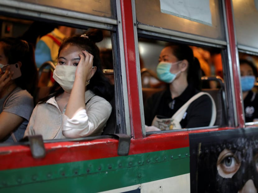 Women travel in a public bus wearing protective masks due to the coronavirus outbreak, in Bangkok, Thailand, on March 9, 2020.