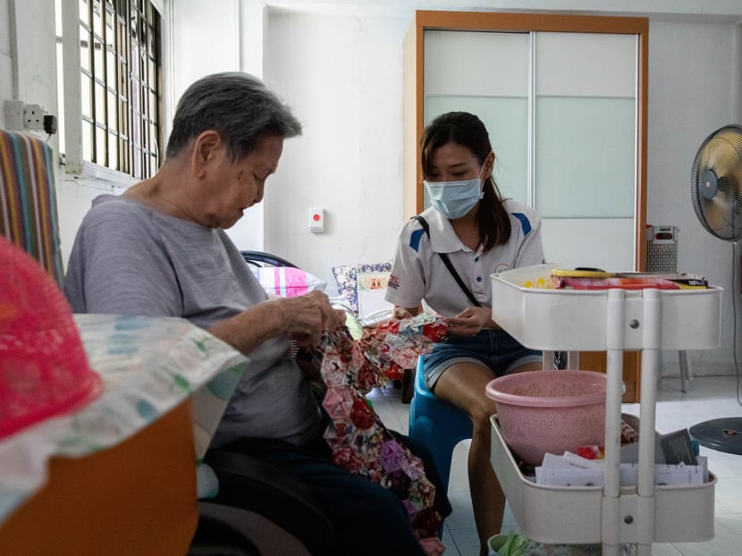 Helping Joy centre manager Irene Woon (right), visiting Mdm Wee Ah Bee at her home on Oct 13, 2021.