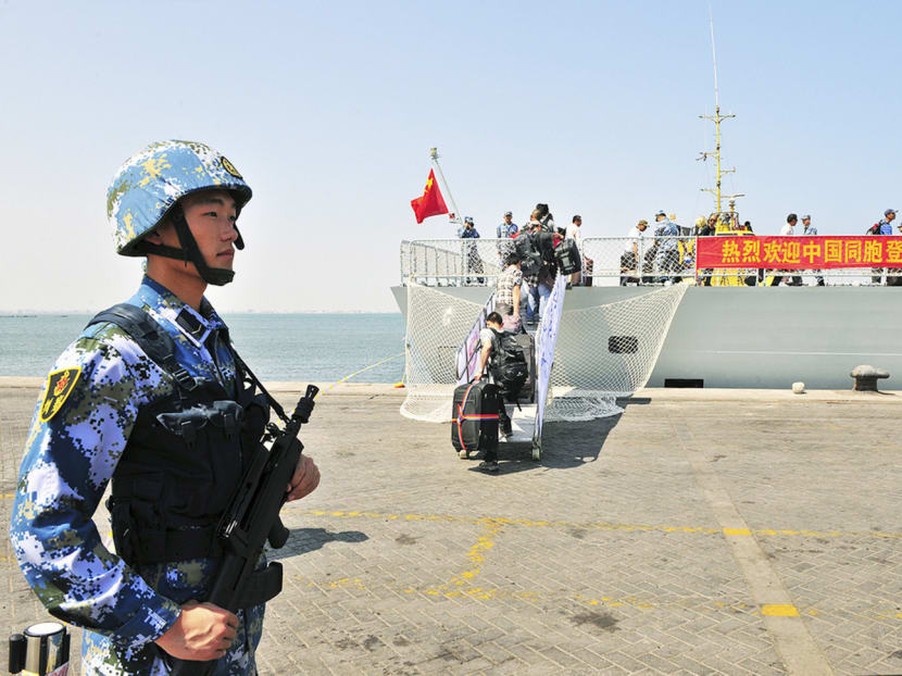 A navy soldier of People’s Liberation Army (PLA) standing guard as Chinese citizens board the naval ship Linyi at a port in Aden. China’s  navy has fended off pirates in the Gulf of Aden since 2012, and rescued civilians trapped in Yemen in 2015. Photo: Reuters