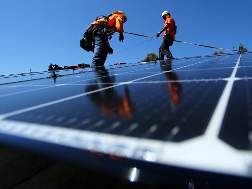 Workers install solar panels on the roof of a residential home in San Diego, California. By the end of January, US President Donald Trump must decide whether to impose wide-ranging tariffs on imports of solar cells, most of which come from China. Photo: Reuters