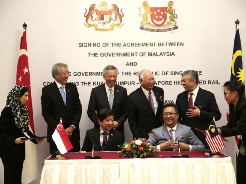 Singapore's PM Lee Hsien Loong and Malaysia's PM Najib Razak witness the signing of the Kuala Lumpur-Singapore High Speed Rail agreement in Putrajaya on Dec 13, 2016. TODAY file photo