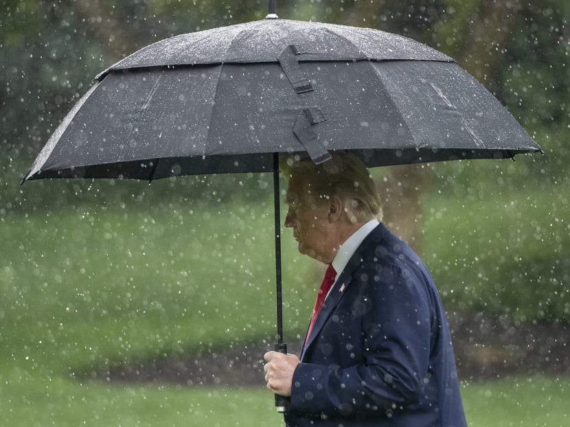 US President Donald Trump walks to Marine One in the rain on the South Lawn of the White House on June 11, 2020.