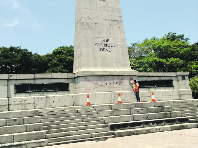 A worker cleaning the Cenotaph after the reported vandalism. Photo: Amanda Lee