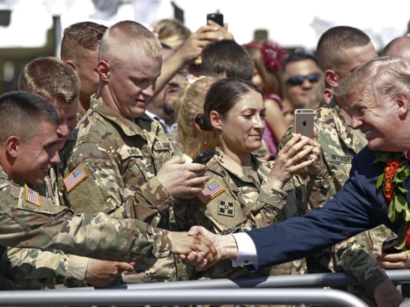 US President Donald Trump greets servicemen after arriving on Friday, Nov 3, 2017 at Joint Base Pearl Harbor Hickam in Honolulu. Photo: AP