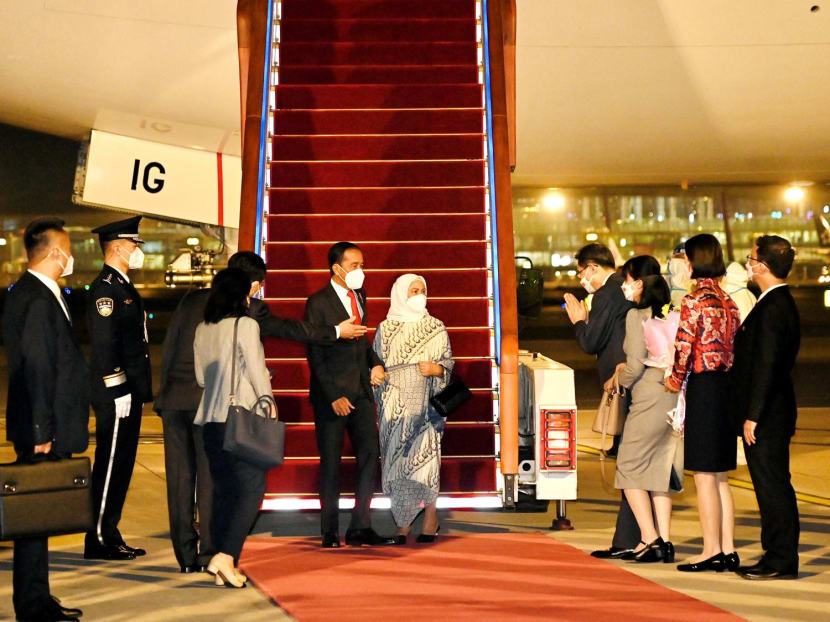 Indonesia's President Joko Widodo and his wife Iriana Widodo are greeted by China's Assistant Minister of Foreign Affairs Wu Jianghao as they arrive at the Beijing Capital International Airport in Beijing, China, July 25, 2022.