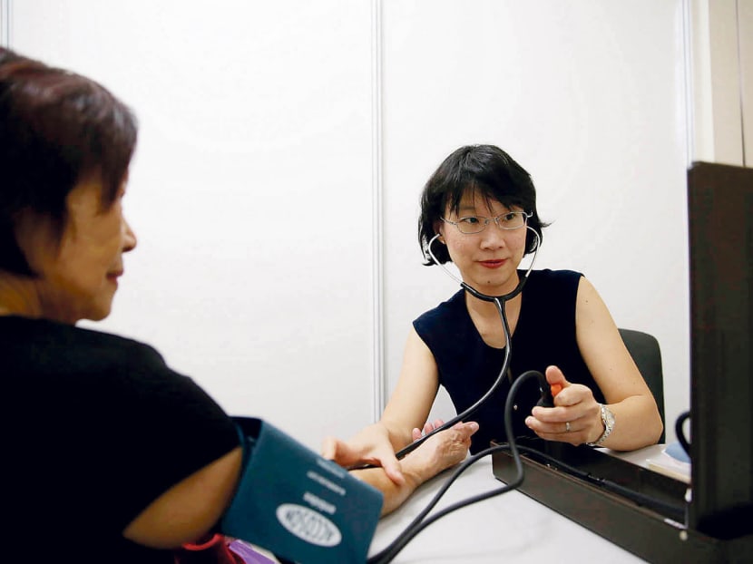Dr Peggy Yeo (right) conducting a consultation with a resident during Project Big Heart. Photo: Wee Teck Hian