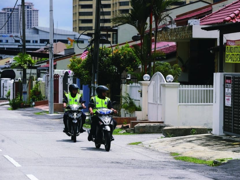 A file picture of police patrolling at a neighbourhood. The officer who rescued an abandoned seven-year-old girl from a flat in Penang was disheartened when she saw the girl’s condition. Photo: The Malay Mail Online