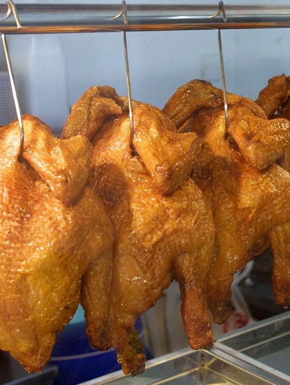 Roast chicken on display at a chicken rice stall.