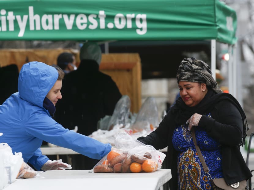 Volunteers from City harvest distribute food in Harlem on March 28, 2020 in New York City. With tens of thousands of New Yorkers out of work due to the epidemic, New York food banks are facing an influx of newcomers who never before would have needed them. Volunteers from City harvest distribute food in Harlem on March 28, 2020 in New York City. With tens of thousands of New Yorkers out of work due to the epidemic, New York food banks are facing an influx of newcomers who never before would have needed them.