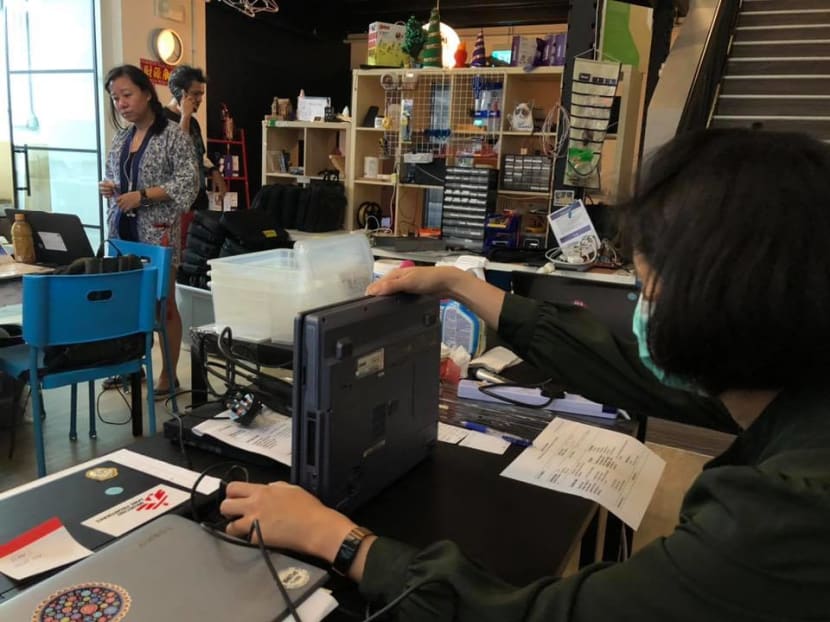 Members of the Engineering Good non-profit group working to prepare laptops to give to children from low-income families for home-based learning.