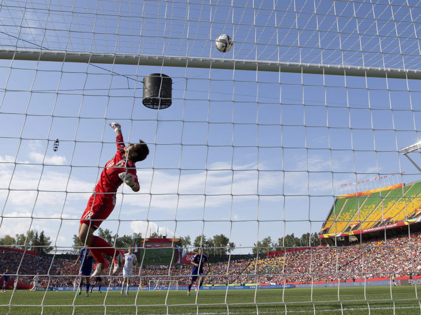 Japan goalkeeper Ayumi Kaihori (18) makes a save against England during the second half of a semifinal in the FIFA Women's World Cup soccer tournament, Wednesday, July 1, 2015, in Edmonton, Alberta, Canada. Photo: AP