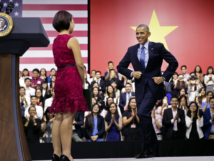 President Barack Obama being introduced by Ms Tu Ngo, a member of the YSEALI (Young Southeast Asian Leaders Initiative) Network, left, as he arrives to speak to Vietnamese young people during a town hall-style event at the GEM Center in Ho Chi Minh City, Vietnam, on Wednesday, May 25, 2016. Photo: AP