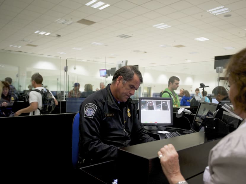 A US Department of Homeland Security officer does a preclearance check of a passenger flying to the US, at Shannon Airport in Ireland, June 6, 2012. Photo: The New York Times