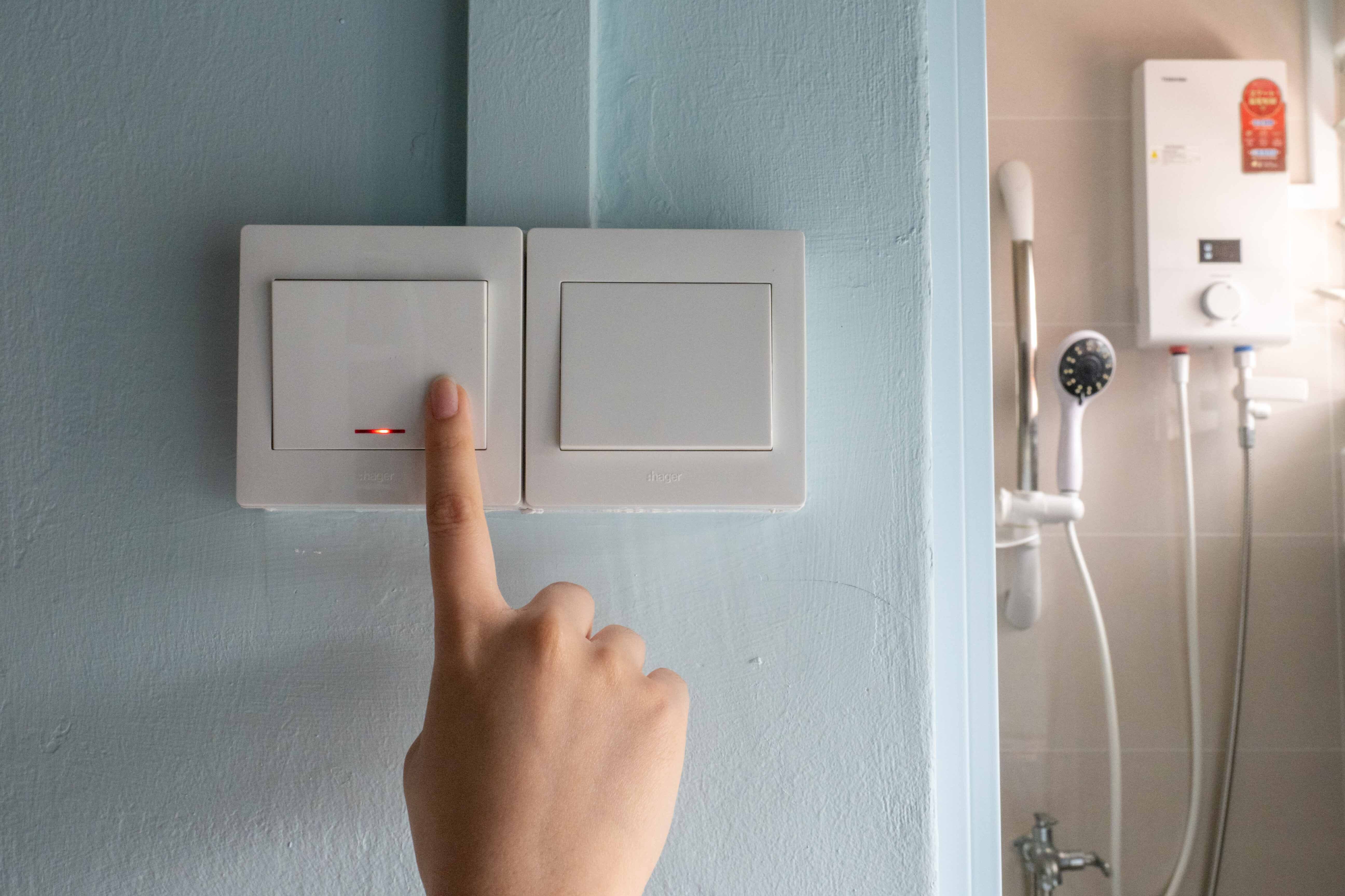 A double pole switch outside a bathroom being pressed for a water heater that is typically installed in public flats. Such switches should be used, electricians said, instead of a power socket for a standard three-pin plug often seen in other home appliances. A double pole switch outside a bathroom being pressed for a water heater that is typically installed in public flats. Such switches should be used, electricians said, instead of a power socket for a standard three-pin plug often seen in other home appliances.