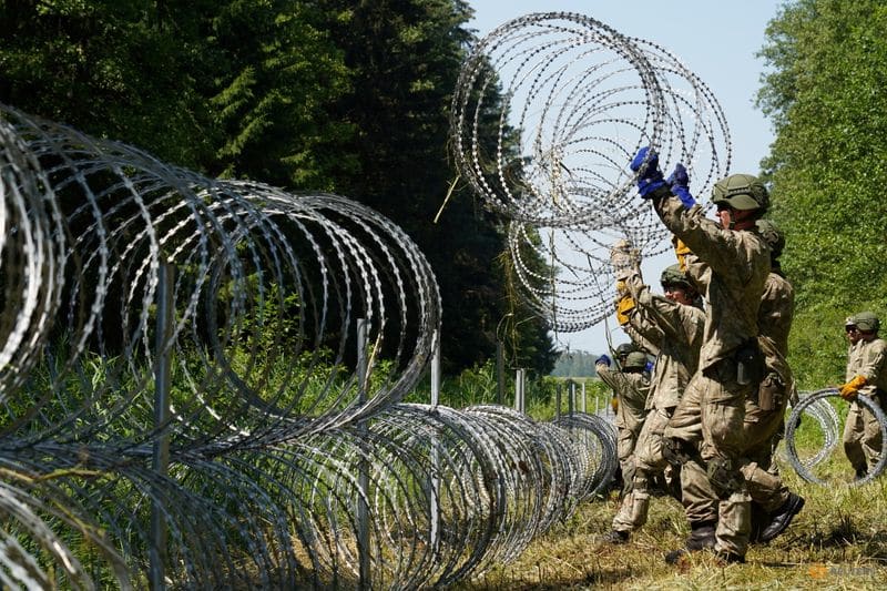 Poland says Belarus lets migrants cross border in 'hybrid war' with EU