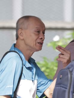 Lee Chook Lim gesturing as he was leaving the State Courts on May 6, 2024.
