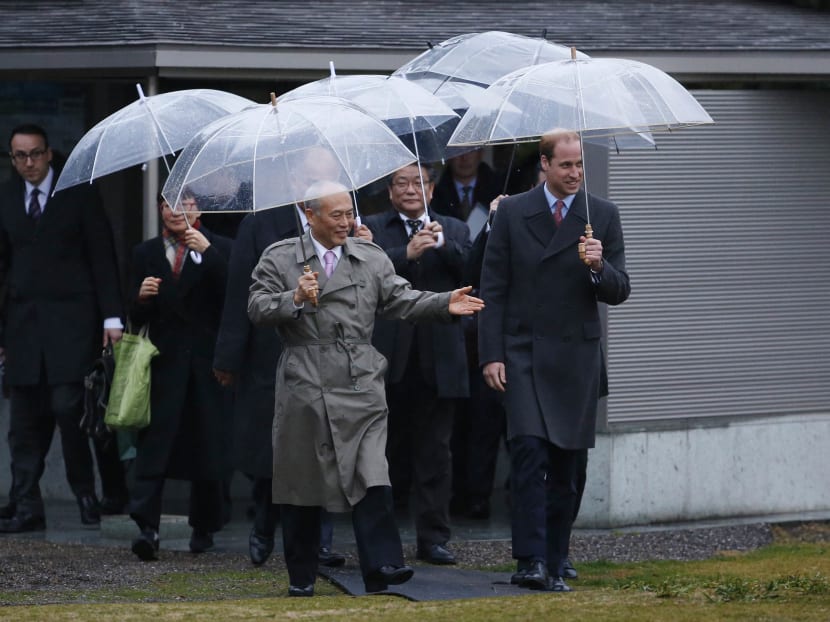 Britain's Prince William (front R), Duke of Cambridge, is escorted by Tokyo Governor Yoichi Masuzoe (front L) upon his arrival at the Hama Rikyu gardens to a restored teahouse where he will be served Japanese tea in the traditional way as a welcome symbolism, in Tokyo February 26, 2015. Prince William flew into Japan on Thursday for a four-day visit.  REUTERS/Toru Hanai