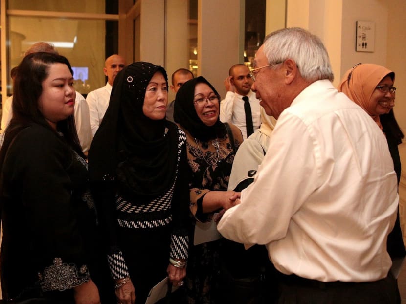 Mr Toh Weng Chong, who trained under the then Social Affairs Minister during NS, with Mr Othman’s family after the service. Photo: Jason Quah