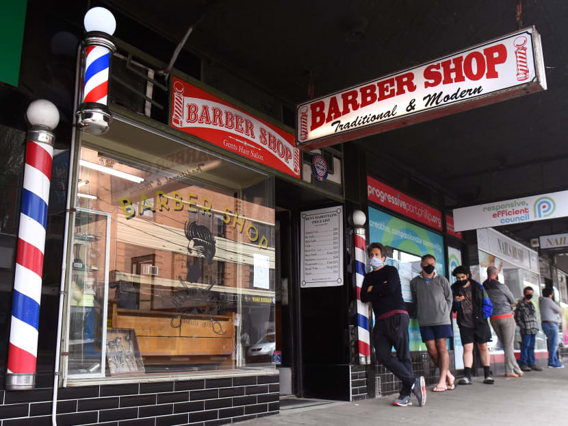Men queue for a haircut outside a barber shop in Melbourne on Oct 19, 2020, as some of the city's three-month-old stay-at-home restrictions due to the Covid-19 coronavirus outbreak were further eased on falling infection rates.