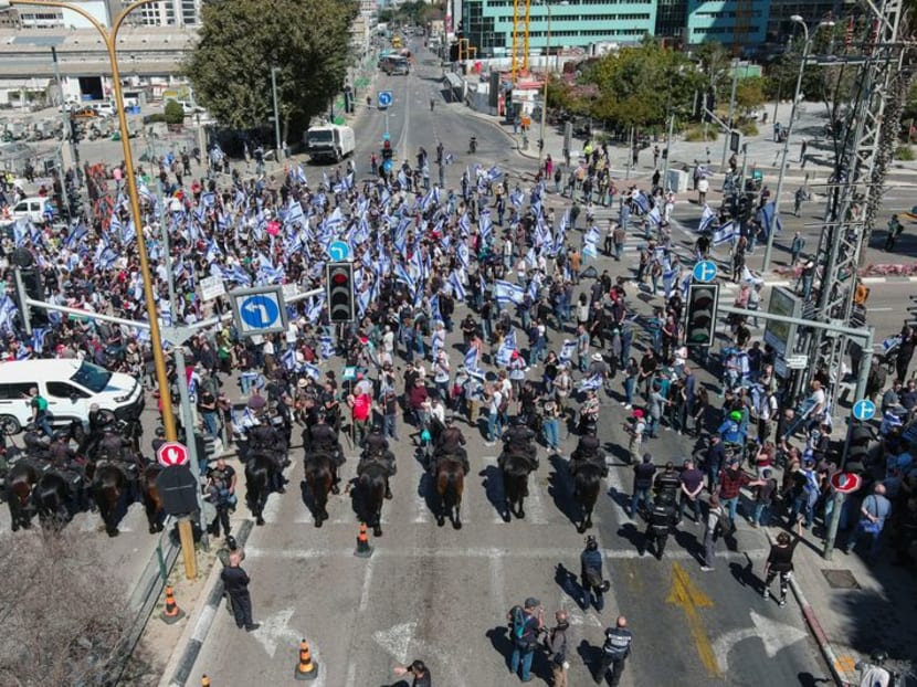An aerial view shows police officers on horses forming a line as people demonstrate during "Day of Resistance", as Israeli Prime Minister Benjamin Netanyahu's nationalist coalition government presses on with its contentious judicial overhaul, in Tel Aviv, Israel March 9, 2023. REUTERS/Ilan Rosenberg