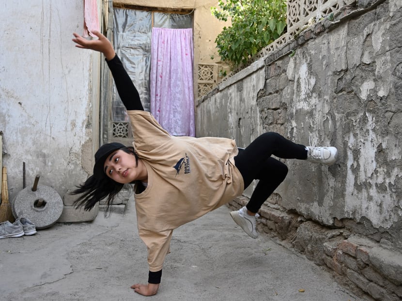 Ms Manizha Talash, the only female member of a group of breakdancers comprised of mostly Hazara boys, practices a move in Kabul, Afghanistan on June 12, 2021.