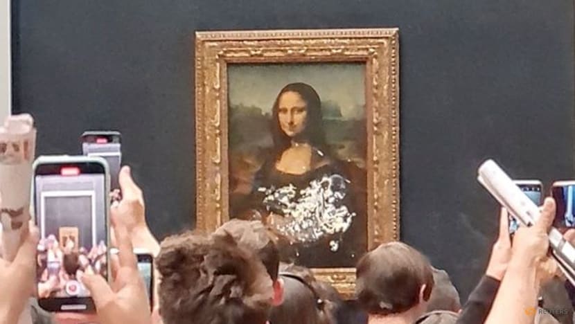 Mona Lisa left unharmed but smeared in cream in climate protest stunt Mona Lisa left unharmed but smeared in cream in climate protest stunt