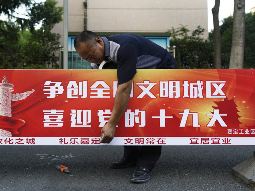A worker setting up a sign that says ‘Welcome 19th National Congress’ in Shanghai. Foreign firms are eager for President Xi Jinping to match the anti-protectionism messages he has been delivering to the world. Photo: AP