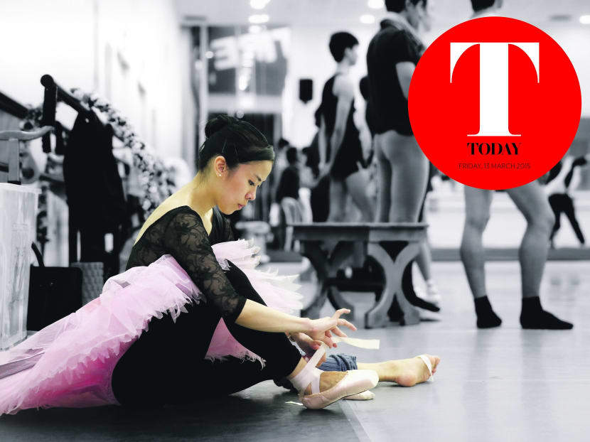 Elaine Heng, who is First Artist at Singapore Dance Theatre, puts on her pointe shoes for rehearsal. Photo: Don Wong