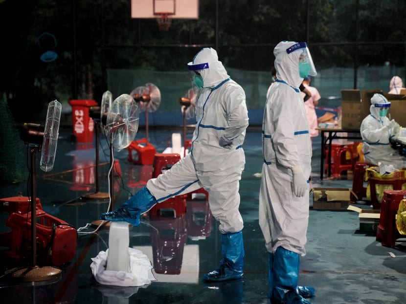Medical workers in protective suits at a makeshift nucleic acid testing site in Panyu district of Guangzhou, Guangdong province, China on May 31, 2021.