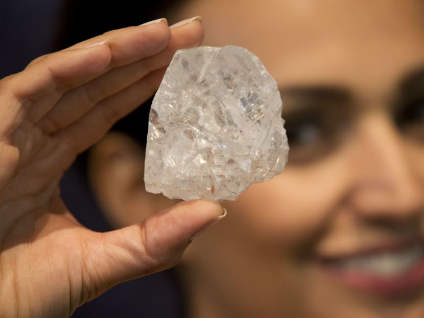 In this Tuesday, June 14, 2016 file photo, a model poses for photographs holding up the largest gem-quality rough cut diamond discovered in over 100 years, the 1109-Carat “Lesedi La Rona” at premises of the Sotheby's auction house in London. Photo: AP