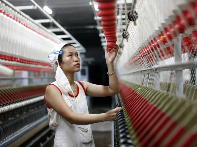 In this Aug 28, 2015 photo, an employee works in a textile factory in Huaibei in central China's Anhui province. Photo: Chinatopix Via AP