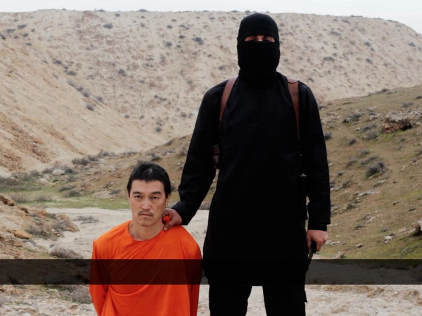 This image made from a video released by Islamic State militants yesterday (Jan 31), purports to show a militant standing next to Japanese journalist Kenji Goto before his beheading by the militant group. Mr Goto was captured in October 2014, after he travelled to Syria to try to win the release of Mr Haruna Yukawa. Photo: AP