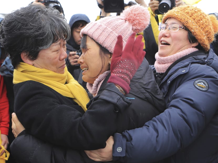 Relatives of missing passengers of the sunken Sewol ferry react as they watch the salvage operation under way in the waters off Jindo, South Korea, Saturday, March 25, 2017. Salvage crews towed a corroded 6,800-ton South Korean ferry and loaded it onto a semi-submersible transport vessel Saturday, completing what was seen as the most difficult part of the massive effort to bring the ship back to shore. Photo: AP