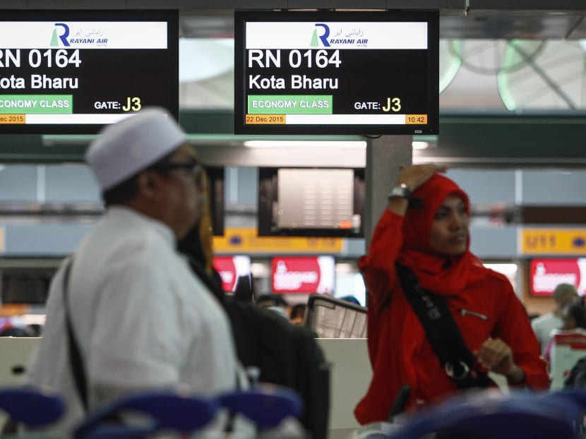 Muslim travellers queue up in front of Rayani Air's check-in counter at Kuala Lumpur International Airport 2. Photo: AP