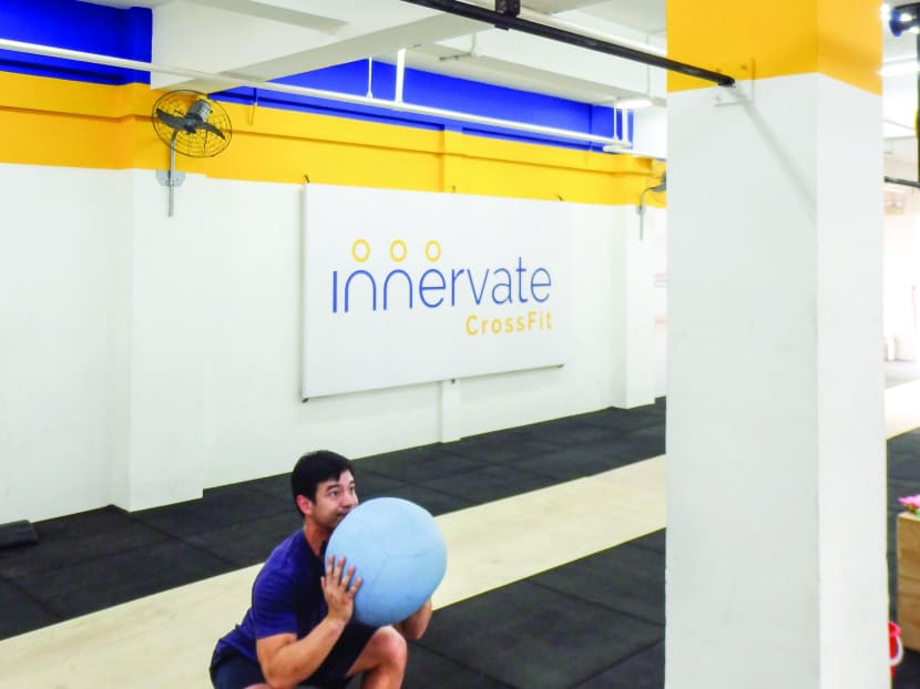 An Innervate CrossFit trainer showing how wall ball is done. Photo: Innervate CrossFit