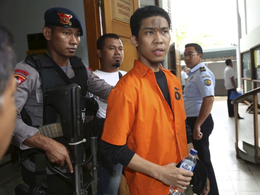 Suspected militant Separiano (centre) is escorted by uniformed and plain-clothed police officers upon arrival for his trial in South Jakarta District Court in Jakarta, Indonesia, today, Nov 6, 2013. The 29-year-old, who plotted to attack the Myanmar Embassy in Indonesia, has gone on trial on charges of terrorism that could result in a death sentence. Photo: AP