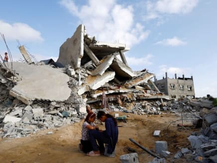 Palestinian children sit next to the site of an Israeli strike on a house, amid the ongoing conflict between Israel and the Palestinian Islamist group Hamas, in Rafah, in the southern Gaza Strip, April 21, 2024.