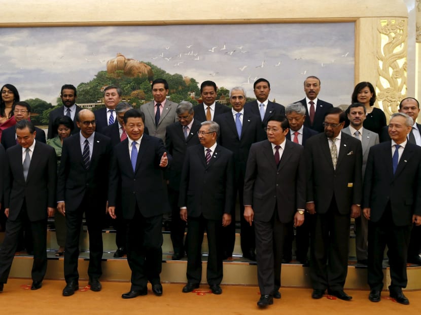 China's President Xi Jinping (front C) guides guests at the Asian Infrastructure Investment Bank launch ceremony at the Great Hall of the People in Beijing in this October 24, 2014 file photo. Reuters file photo