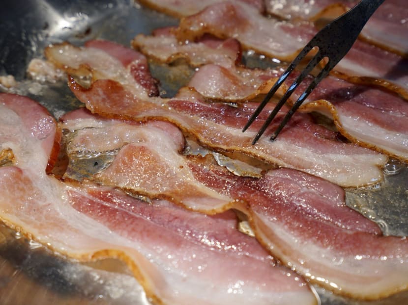 Bacon is fried up in a pan in a kitchen in this photo illustration in Golden, Colorado, on Oct 26, 2015. Photo: Reuters