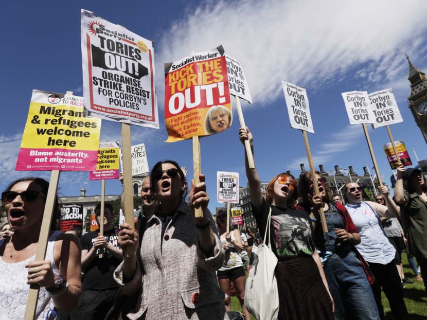 People at Parliament Square in London on Saturday protesting against a possible coalition between the Conservatives and the Democratic Unionist Party of Northern Ireland. Britain now has a weak government, a likely lame-duck prime minister and no negotiating position that could command a parliamentary majority. PHOTO: AP