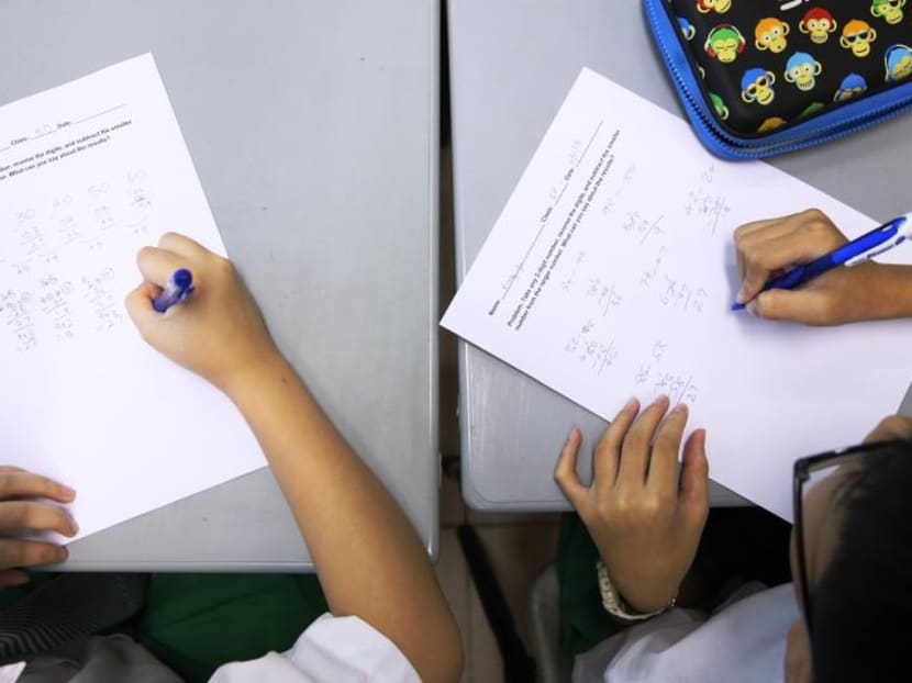 Students filling up a mathematics worksheet in a primary school in Singapore. A July 2017 survey revealed that a majority of parents feel that the primary school curriculum should be made more manageable. TODAY file photo