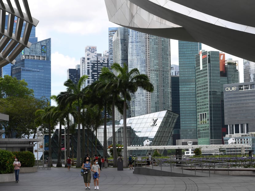 People walk through the promenade at Marina Bay Sands hotel and resorts in Singapore on Dec 14, 2020. People walk through the promenade at Marina Bay Sands hotel and resorts in Singapore on Dec 14, 2020.