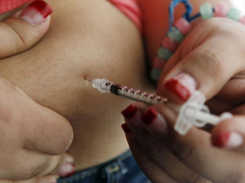 A teenager diagnosed with diabetes giving herself an injection of insulin.  Diabetic kidney disease is a top complication of poorly controlled diabetes. AP file photo