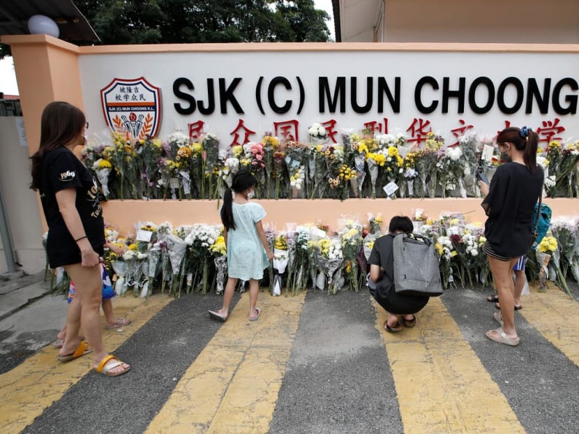 People placing bouquets of flowers at the entrance of a school in Kuala Lumpur, Malaysia on Dec 18, 2022. Several teachers and students from the school were on an unofficial camping trip at a farm that was hit by a landslide. People placing bouquets of flowers at the entrance of a school in Kuala Lumpur, Malaysia on Dec 18, 2022. Several teachers and students from the school were on an unofficial camping trip at a farm that was hit by a landslide.