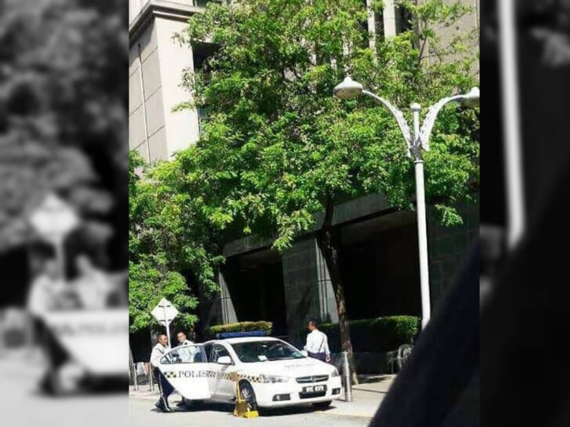 Malaysian police officers found themselves on the wrong side of the law after they discovered that the tyres of their own patrol car had been clamped. Photo: MALAY MAIL ONLINE