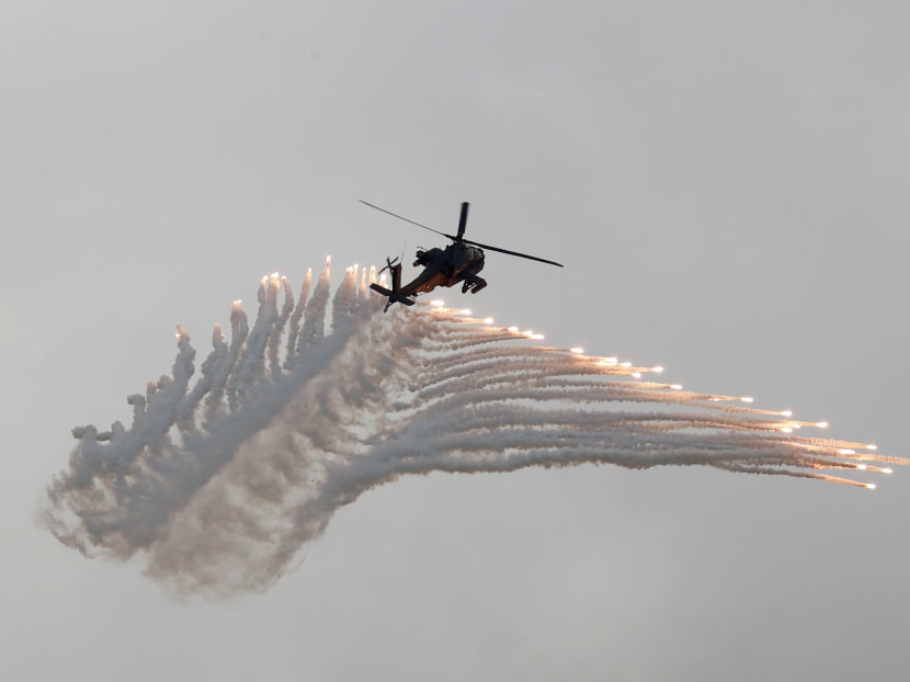 Photo of the day: AH-64 Apache helicopter fires flares during Han Kuang military drill simulating the China's People's Liberation Army (PLA) invading the island, at Ching Chuan Kang Air Base, in Taichung, Taiwan.